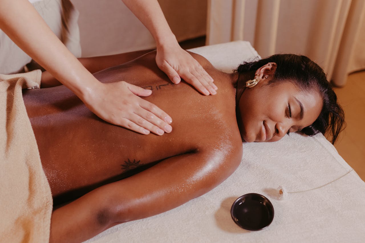 services-04 Woman enjoying a relaxing massage therapy session at the spa. Ideal for wellness or relaxation themes.