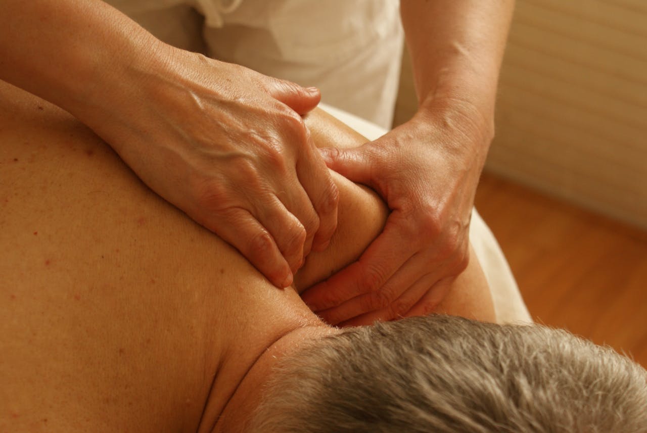 heros-img Close-up of a therapist giving a relaxing shoulder massage, enhancing wellness and stress relief.